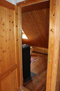 Ferienhaus-Uckermark Schlafzimmer im Obergeschoss rechts mit Kaminofen für Winter Ferien und Urlaub im Boitzenburger Land schon ab 29,- Euro pro Tag
